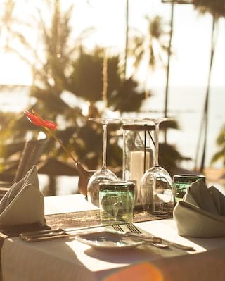 Close-up view of an outdoor formal restaurant table at sunset